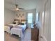 Comfortable bedroom with two twin beds, ceiling fan, and natural light at 444 Halter Dr, Apopka, FL 32712