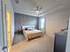 This bedroom features a tray ceiling, ceiling fan, and an accent wall behind the bed at 444 Halter Dr, Apopka, FL 32712