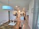 Dining room area looking towards the kitchen with ample lighting and adjacent access to the living room at 444 Halter Dr, Apopka, FL 32712