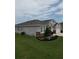 Landscaped yard surrounding a modern home, showcasing the home's exterior at 444 Halter Dr, Apopka, FL 32712