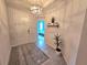 Bright foyer features tile flooring, modern light fixture, and view to bedroom at 444 Halter Dr, Apopka, FL 32712