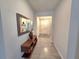 Hallway with wood-look tile, console table, and decorative mirror at 444 Halter Dr, Apopka, FL 32712