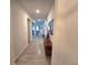 Hallway with wood-look tile, console table, and view to living room at 444 Halter Dr, Apopka, FL 32712