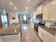 Kitchen featuring white cabinetry, stainless steel appliances, tile backsplash, and granite countertops at 444 Halter Dr, Apopka, FL 32712