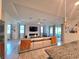Open-concept living room featuring tile floors, large sectional, fireplace, and access to the patio at 444 Halter Dr, Apopka, FL 32712