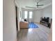 A welcoming living room with neutral tones, lots of natural light, and tiled flooring throughout the space at 444 Halter Dr, Apopka, FL 32712
