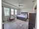Main bedroom featuring large bed, ceiling fan, tray ceilings, and tile floors at 444 Halter Dr, Apopka, FL 32712