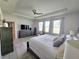 Bright main bedroom featuring neutral tones, tray ceiling, ceiling fan, and many windows allowing lots of natural light at 444 Halter Dr, Apopka, FL 32712
