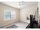 Bright spare bedroom with wood-look floors, neutral paint, ceiling fan, and a window for natural light at 4833 Cypress Woods Dr # 4205, Orlando, FL 32811