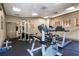 Community gym with modern exercise equipment and natural light at 4833 Cypress Woods Dr # 4205, Orlando, FL 32811