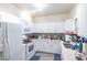 Bright kitchen with white cabinets, modern appliances, and ample counter space at 4833 Cypress Woods Dr # 4205, Orlando, FL 32811