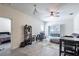Bright living room featuring wood-look tile flooring, ceiling fan, sliding glass doors to balcony, and neutral paint at 4833 Cypress Woods Dr # 4205, Orlando, FL 32811