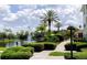 Community pond with fountain, lush landscaping, and walking path at 4833 Cypress Woods Dr # 4205, Orlando, FL 32811