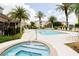 Community pool area with hot tub, palm trees, lounge chairs, and well-maintained landscaping at 4833 Cypress Woods Dr # 4205, Orlando, FL 32811