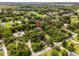 Aerial view of the home with a location pin, surrounded by lush greenery and neighborhood at 489 Grape Ave, St Cloud, FL 34769