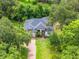 Charming home with a brick driveway nestled in lush greenery, offering privacy and curb appeal at 489 Grape Ave, St Cloud, FL 34769