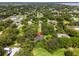 Aerial view of the home with a location pin, surrounded by lush greenery and neighborhood at 489 Grape Ave, St Cloud, FL 34769