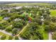 Aerial view of the property with mature trees and landscaping. The home is marked with a location pin at 489 Grape Ave, St Cloud, FL 34769