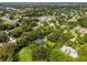 Aerial view of the neighborhood with lush trees, featuring the home's location at 489 Grape Ave, St Cloud, FL 34769
