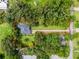 Aerial view outlining the property lines of the home, showcasing its location among lush greenery at 489 Grape Ave, St Cloud, FL 34769