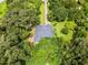 Secluded home with long driveway surrounded by verdant trees and greenery, providing ultimate privacy at 489 Grape Ave, St Cloud, FL 34769