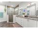 Modern bathroom featuring a double sink vanity and glass enclosed shower at 489 Grape Ave, St Cloud, FL 34769