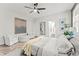 Spacious bedroom with seating area, ensuite bathroom, and herringbone floors at 489 Grape Ave, St Cloud, FL 34769