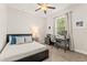 Bright bedroom featuring a comfortable bed, a large window, and a dedicated workspace at 489 Grape Ave, St Cloud, FL 34769