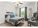 Cozy bedroom with a comfortable bed, soft lighting, and a dedicated workspace for study or work at 489 Grape Ave, St Cloud, FL 34769