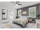 Bright bedroom with stylish ceiling fan, herringbone floors and large windows at 489 Grape Ave, St Cloud, FL 34769
