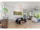Spacious dining area with modern light fixture, adjacent to living area and kitchen, perfect for gatherings at 489 Grape Ave, St Cloud, FL 34769