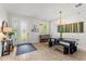 Open dining area with a rustic table, decorative lighting, and a view of the entryway at 489 Grape Ave, St Cloud, FL 34769