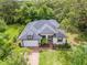Beautifully landscaped home with a brick driveway, attached garage, and a charming front entrance at 489 Grape Ave, St Cloud, FL 34769