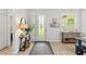 Bright foyer with stylish decor, decorative front door, wood floors, and window at 489 Grape Ave, St Cloud, FL 34769