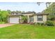 Charming single-story home boasting a manicured lawn, paver driveway, and an attached two-car garage at 489 Grape Ave, St Cloud, FL 34769