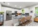 Spacious kitchen featuring an island with barstool seating, stainless steel appliances, and sleek white cabinetry at 489 Grape Ave, St Cloud, FL 34769
