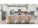 Modern kitchen featuring white cabinets, stainless steel appliances, and a granite countertop island with seating at 489 Grape Ave, St Cloud, FL 34769