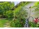 Outdoor shower surrounded by lush tropical plants, ferns, and foliage, creating a private oasis at 489 Grape Ave, St Cloud, FL 34769