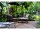 Landscaped patio with a conversation set, perfect for relaxing outdoors at 489 Grape Ave, St Cloud, FL 34769