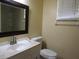 Cozy bathroom featuring a vanity with sink, toilet, and a shower with glass doors at 5224 Florida Holly Dr, Orlando, FL 32811