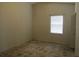 Empty bedroom with neutral walls, single window, and tiled floor at 5224 Florida Holly Dr, Orlando, FL 32811