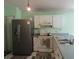 Kitchen with white cabinets, stainless refrigerator, and laminate countertops at 5224 Florida Holly Dr, Orlando, FL 32811