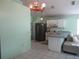 Bright kitchen with laminate counter, tile floors, and a stainless steel refrigerator at 5224 Florida Holly Dr, Orlando, FL 32811