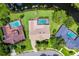 A full aerial view of the property with a private pool, mature trees, and water view at 526 Sabal Trail Cir, Longwood, FL 32779