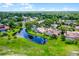 Overhead view of residences backing onto a winding pond, complete with mature trees at 526 Sabal Trail Cir, Longwood, FL 32779
