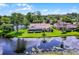 An aerial view of a single-Gathering home with a screened pool, lush greenery, and waterfront views at 526 Sabal Trail Cir, Longwood, FL 32779