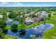 An aerial view of a single-Gathering home with a screened pool, lush greenery, and waterfront views at 526 Sabal Trail Cir, Longwood, FL 32779