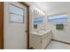 Bathroom featuring double sinks, mirrors, mosaic tile floor, and ample lighting at 526 Sabal Trail Cir, Longwood, FL 32779