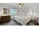 Carpeted bedroom showcasing a bed, side table, dresser, and window at 526 Sabal Trail Cir, Longwood, FL 32779