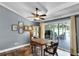 Cozy dining area with a ceiling fan and sliding glass doors leading to the outdoor patio area with brick flooring at 526 Sabal Trail Cir, Longwood, FL 32779